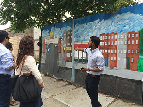 Photo of man and group looking at a Richmond Hill drawing on the street.